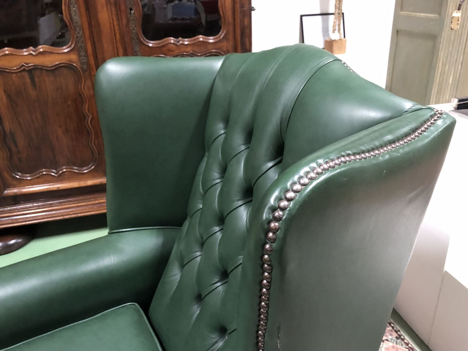 In the 1970s green leather Chesterfield armchair