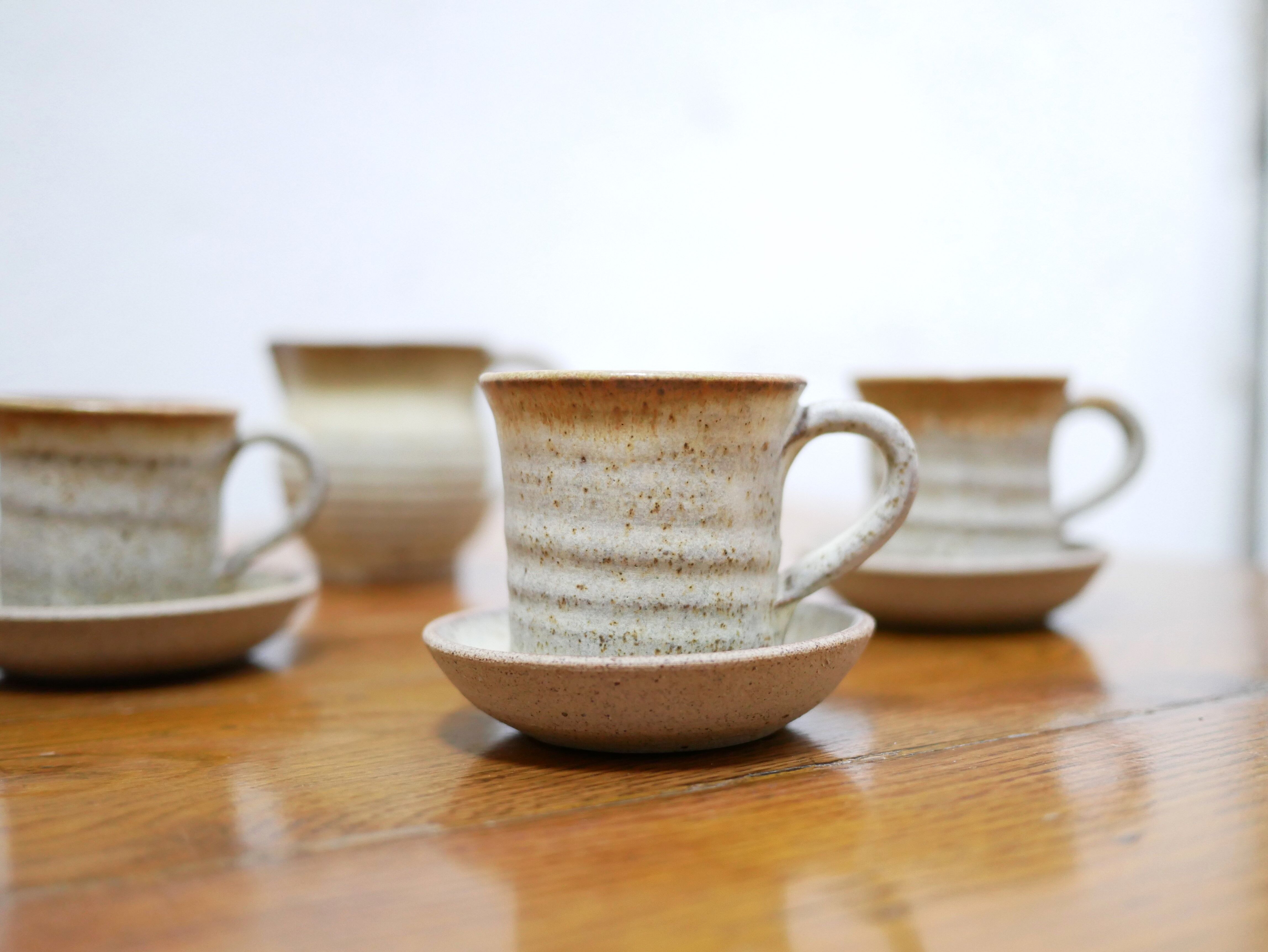 Series of 4 cups and a vintage stoneware milk jug