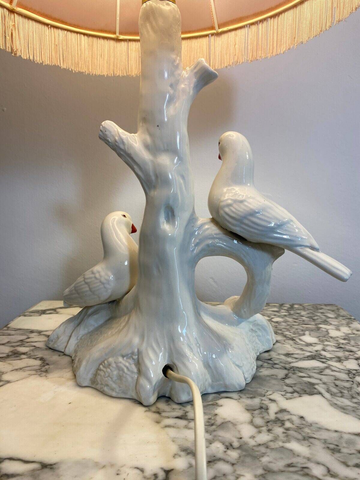 Ceramic lamp with birds, pink fringed shade, 1950s.