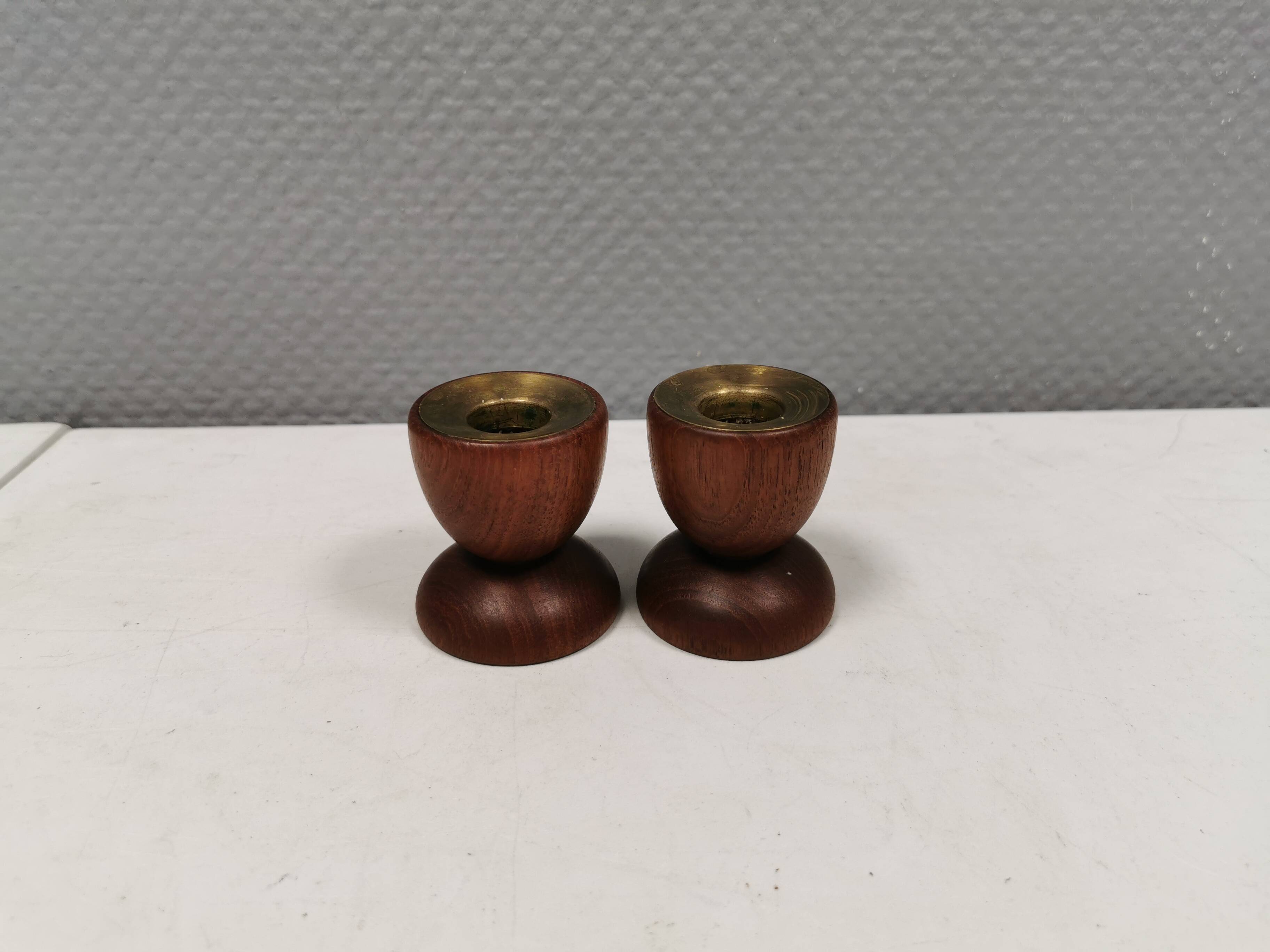 Two beautiful teak candle holders with brass inserts.