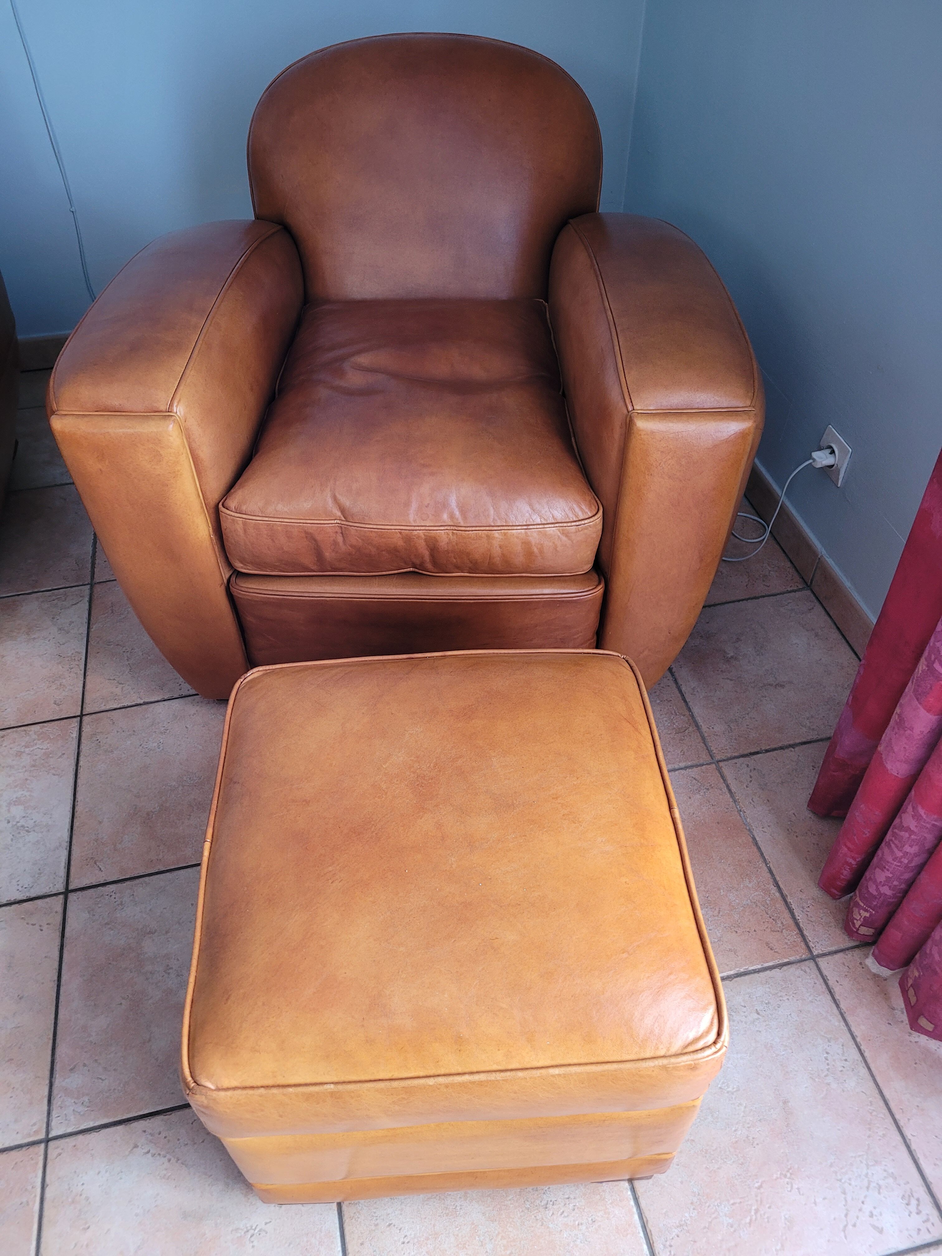 Leather club armchair and its pouf