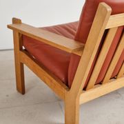 Brutalist armchair in oak and leather by Tage Poulsen, Denmark, 1970s.