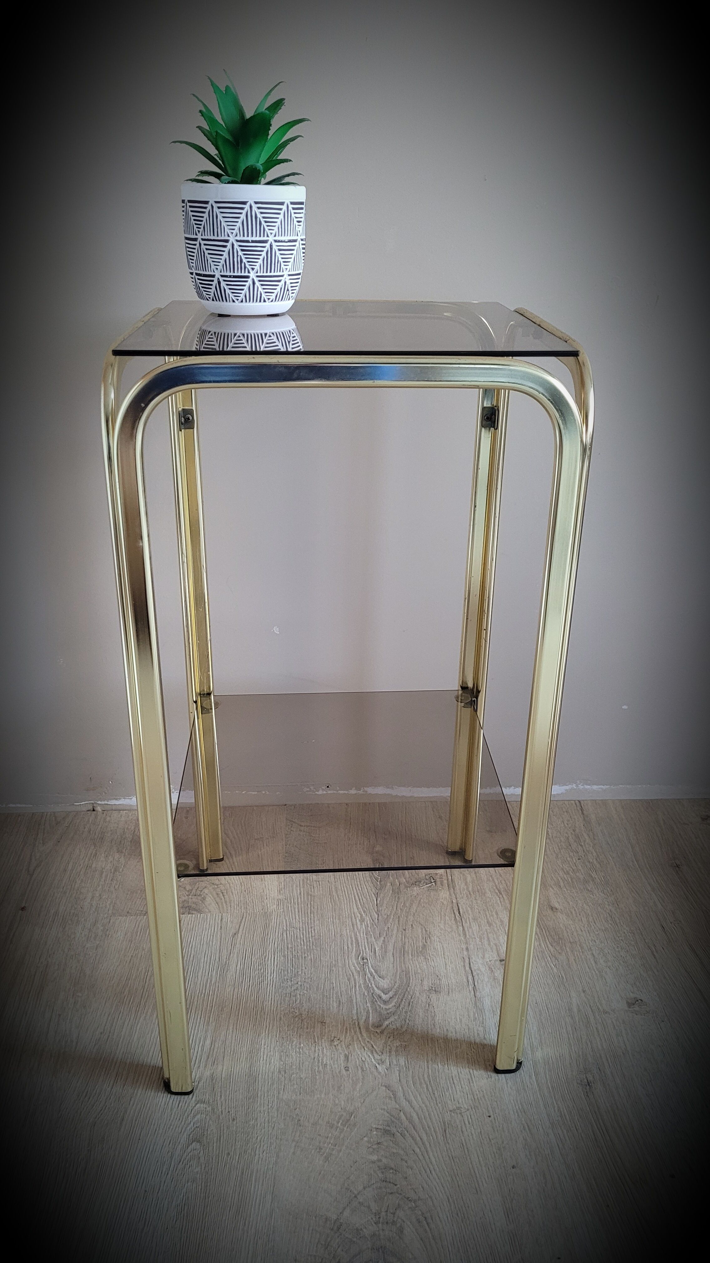 Golden side table and smoked glass