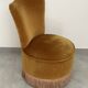 Ochre and fringed pouffe-style armchair