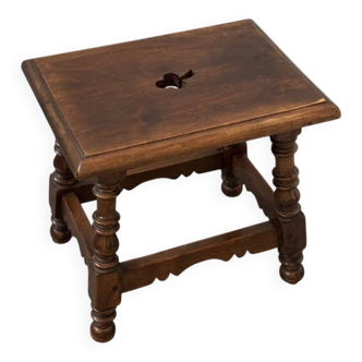 Small antique wooden stool with an openwork pattern.