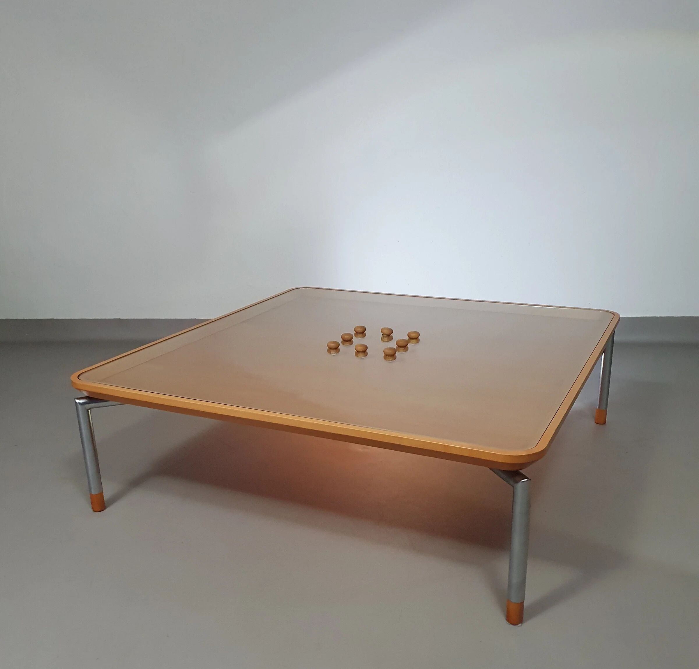 Rare coffee table 110 x 110 x height 35 cm with 8 flange wooden / cork caps in the glass top.