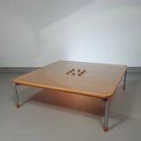 Rare coffee table 110 x 110 x height 35 cm with 8 flange wooden / cork caps in the glass top.