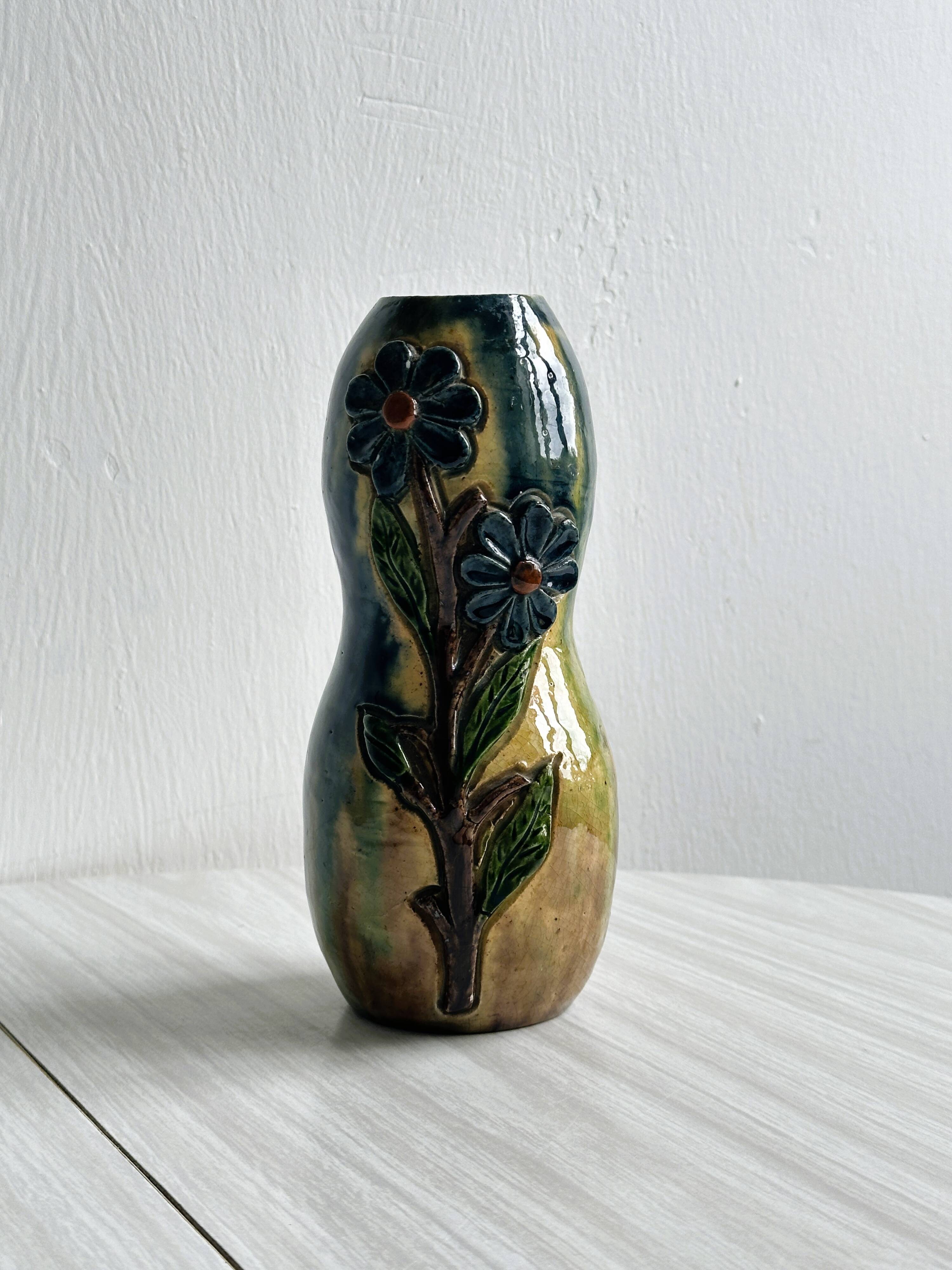 Very colorful glazed earthenware vase, old vase with floral decoration.