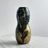 Very colorful glazed earthenware vase, old vase with floral decoration.