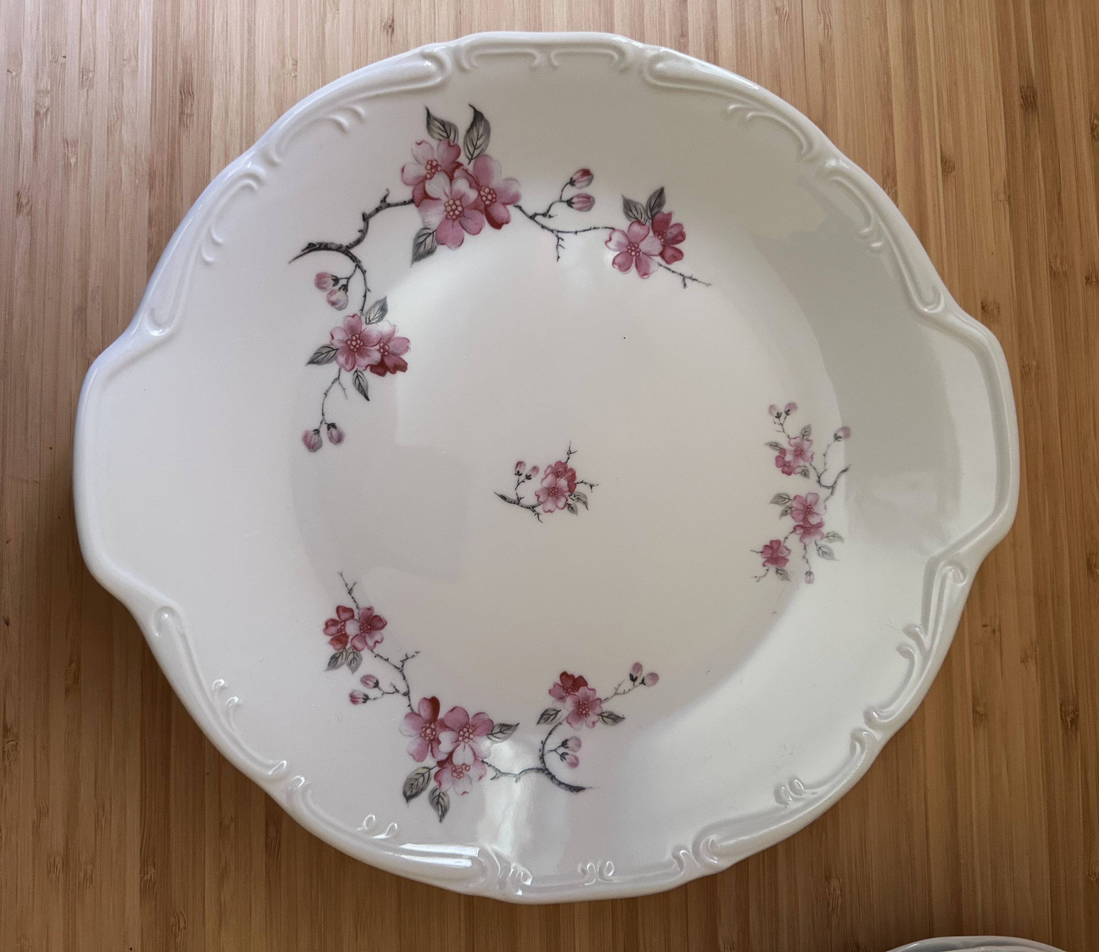 12 plates and 1 serving dish, white porcelain with apple blossom patterns.