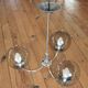 Chrome metal chandelier with smoked glass globes.
