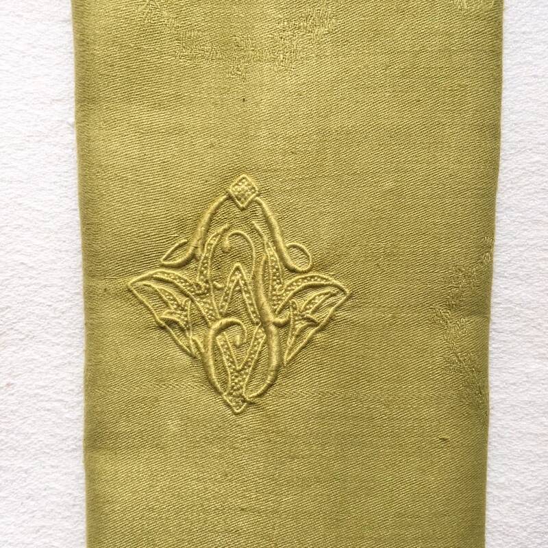 Old embroidered green square table napkin with cutwork