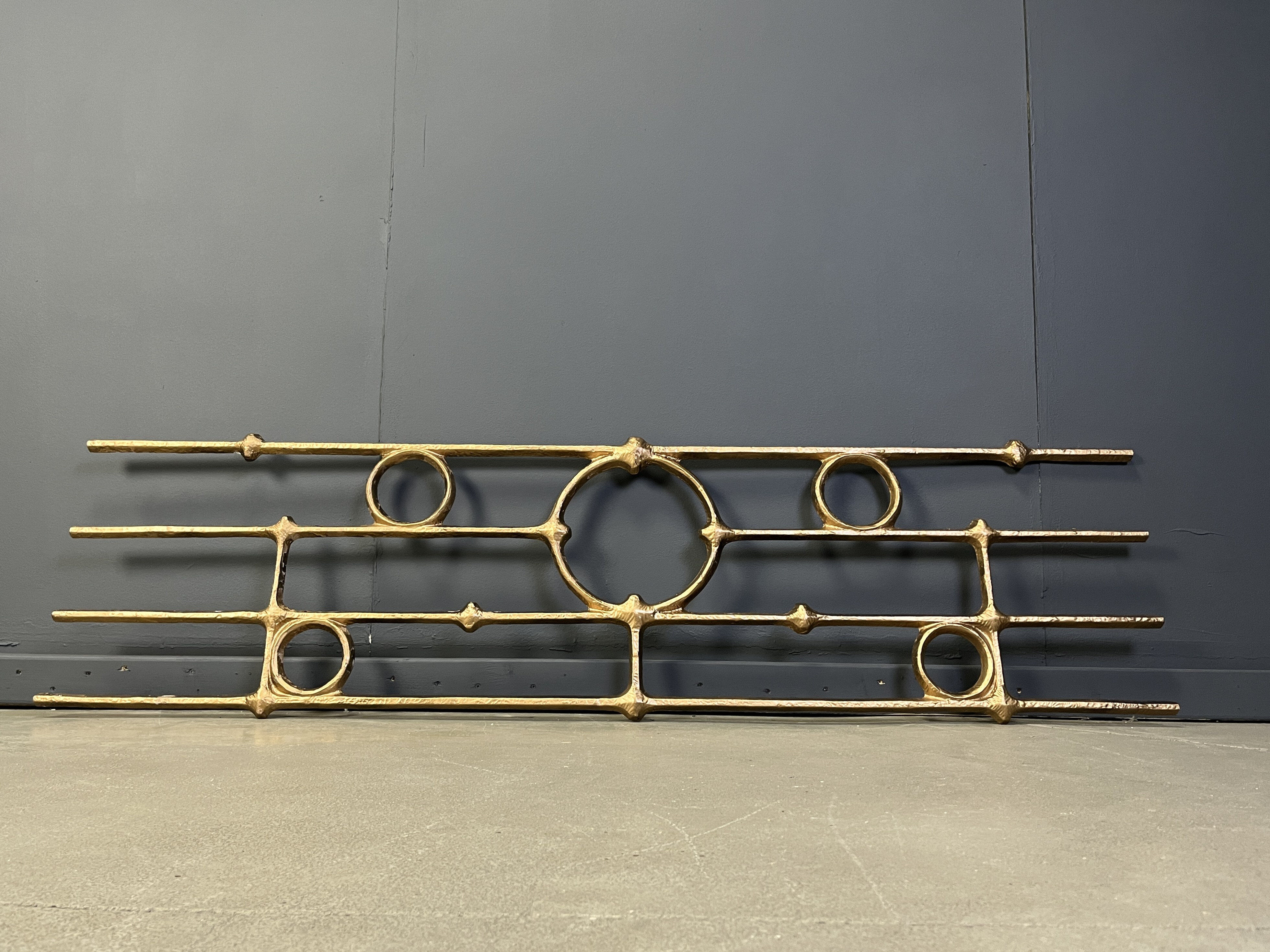Architectural brutalist wall mounted sculpture made from cast metal.