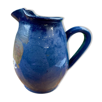 Blue ceramic pitcher with vintage artisan inscription decoration.