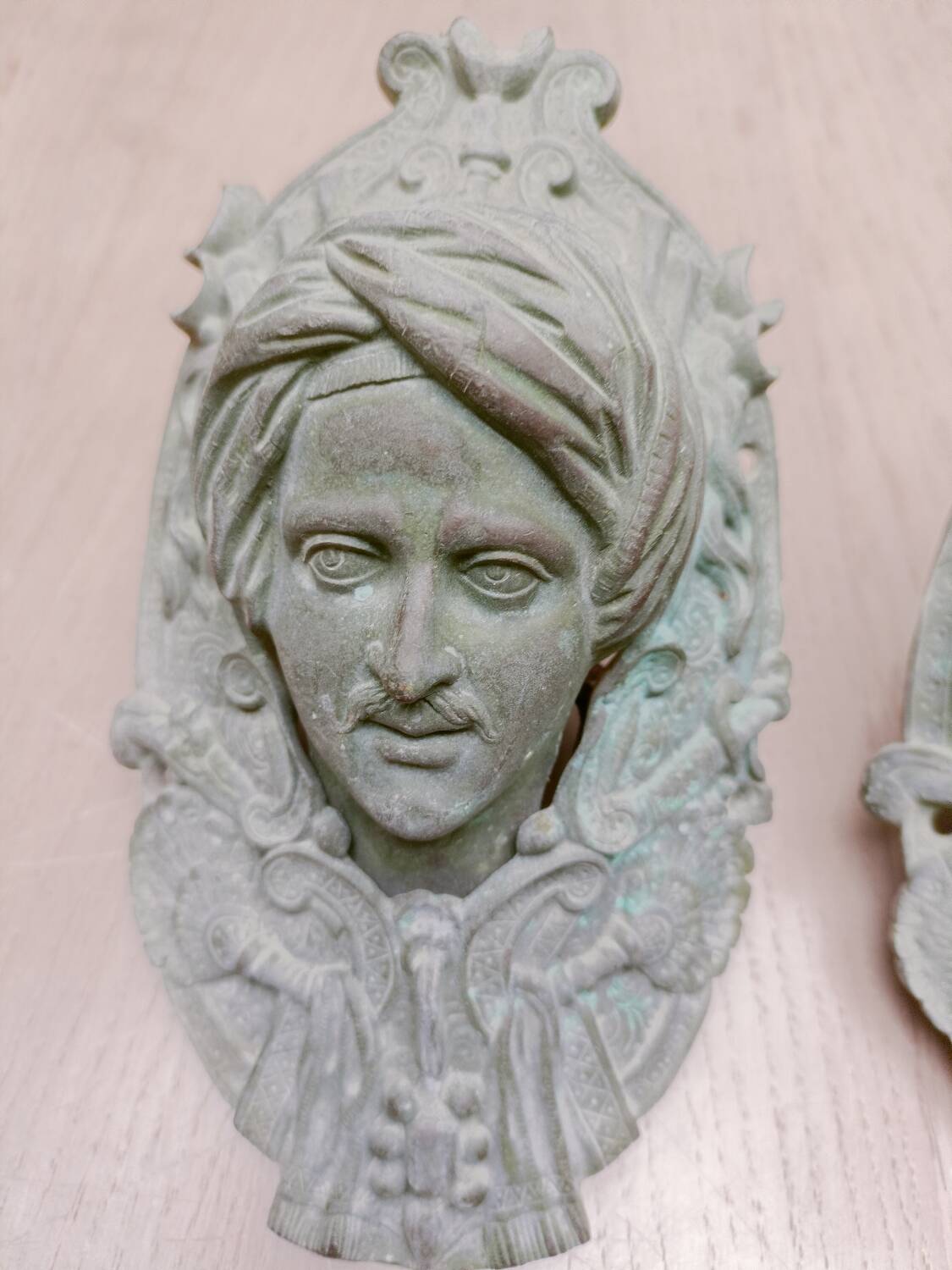 Bronze door knockers and billiard table corners