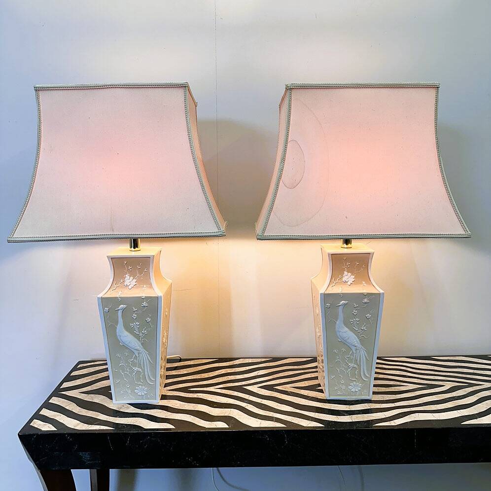 Pair of large cream ceramic table lamps with relief peacocks and fabric shades