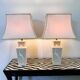 Pair of large cream ceramic table lamps with relief peacocks and fabric shades