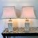Pair of large cream ceramic table lamps with relief peacocks and fabric shades