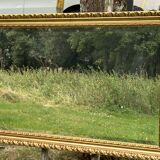 Large beveled mirror in wood and gilded stucco