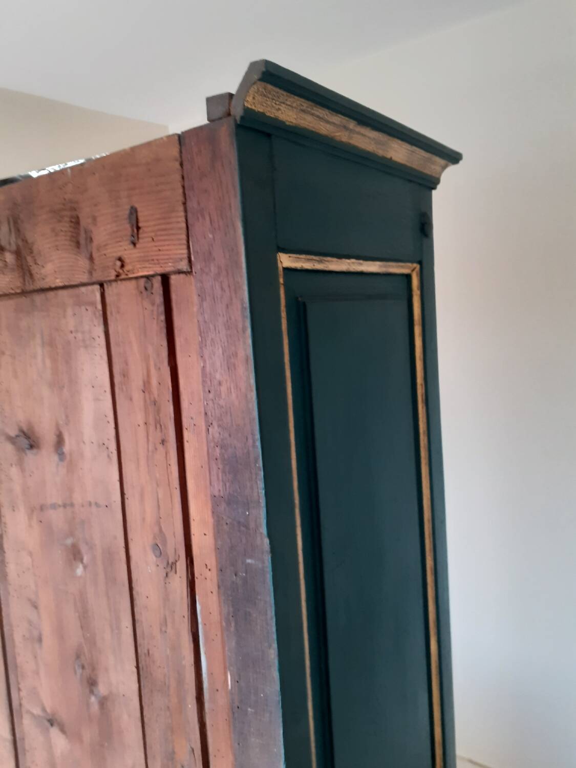 Glass-fronted cabinet in weathered green wood