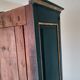 Glass-fronted cabinet in weathered green wood