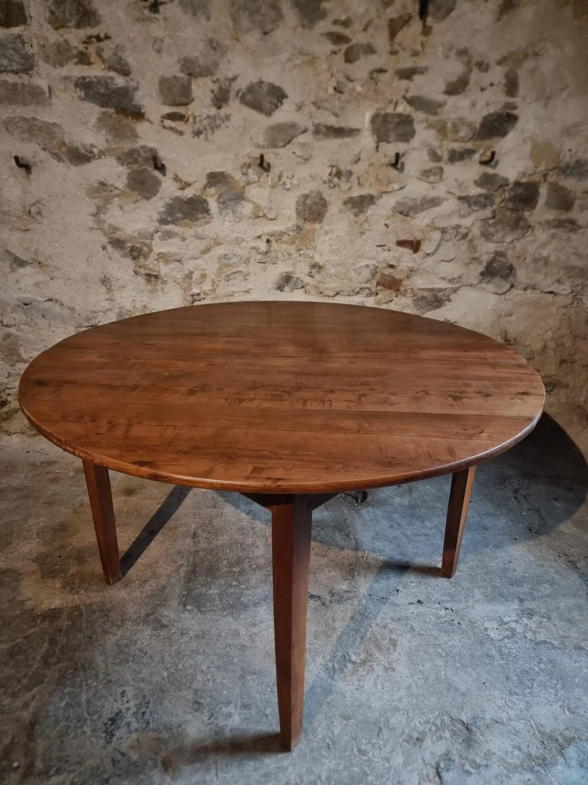 Antique round dining table in cherry wood, France, circa 1920.