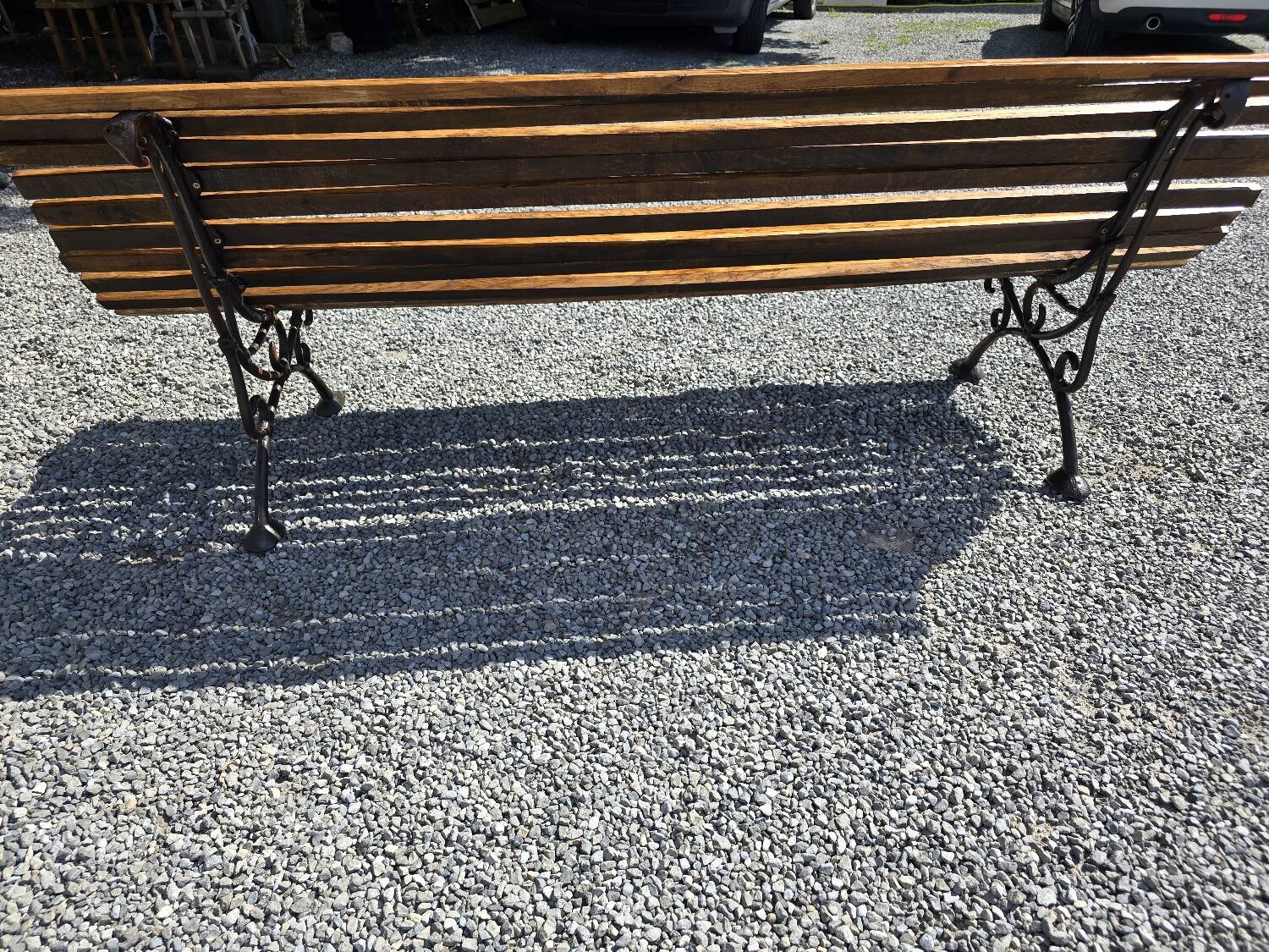 Wooden garden bench with cast iron base