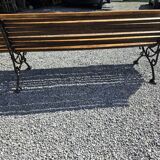 Wooden garden bench with cast iron base