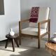 Large armchair in natural wood (teak) with a minimalist design.