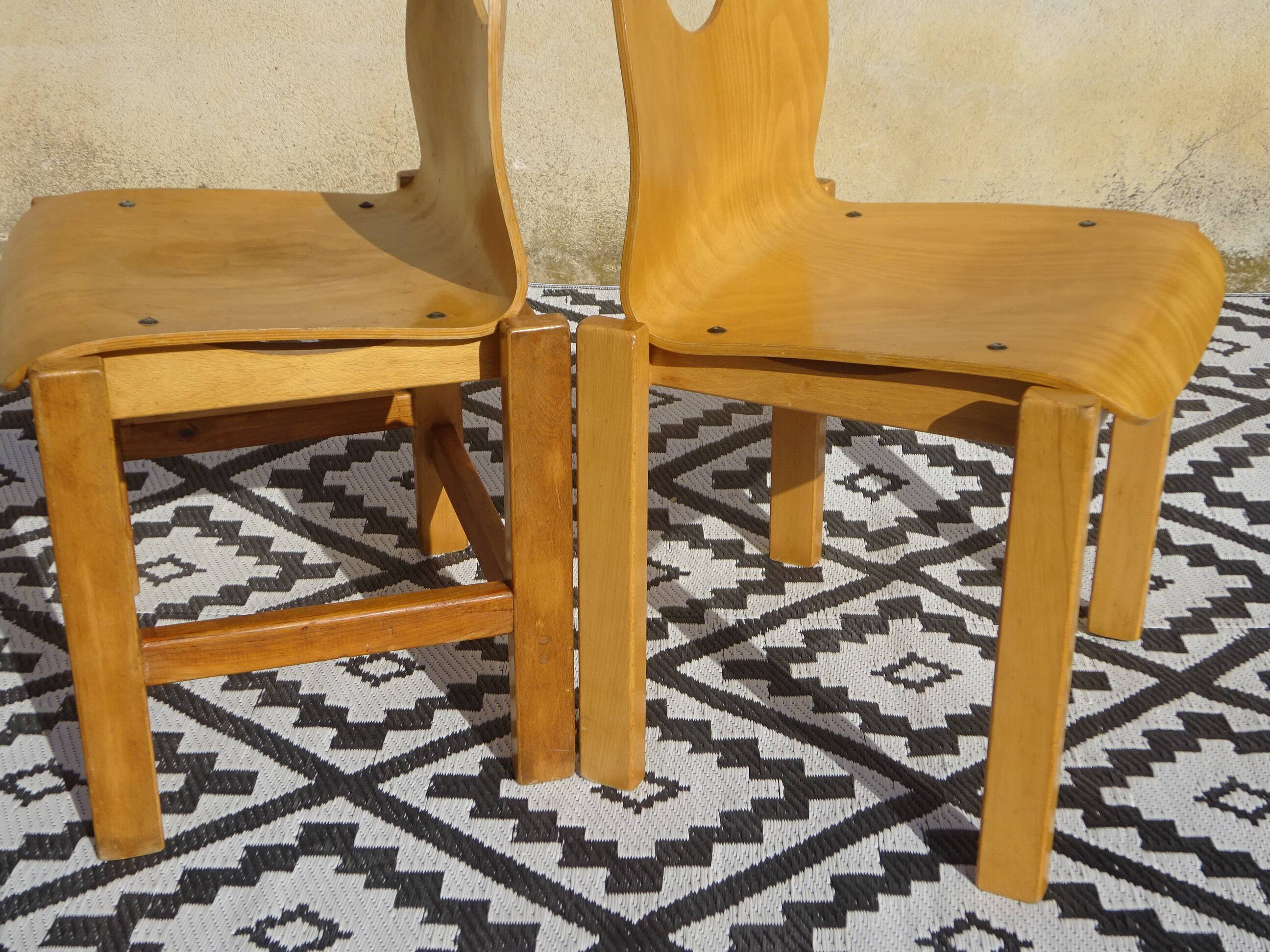 Pair of light wood chairs with post-formed seat and backrest.