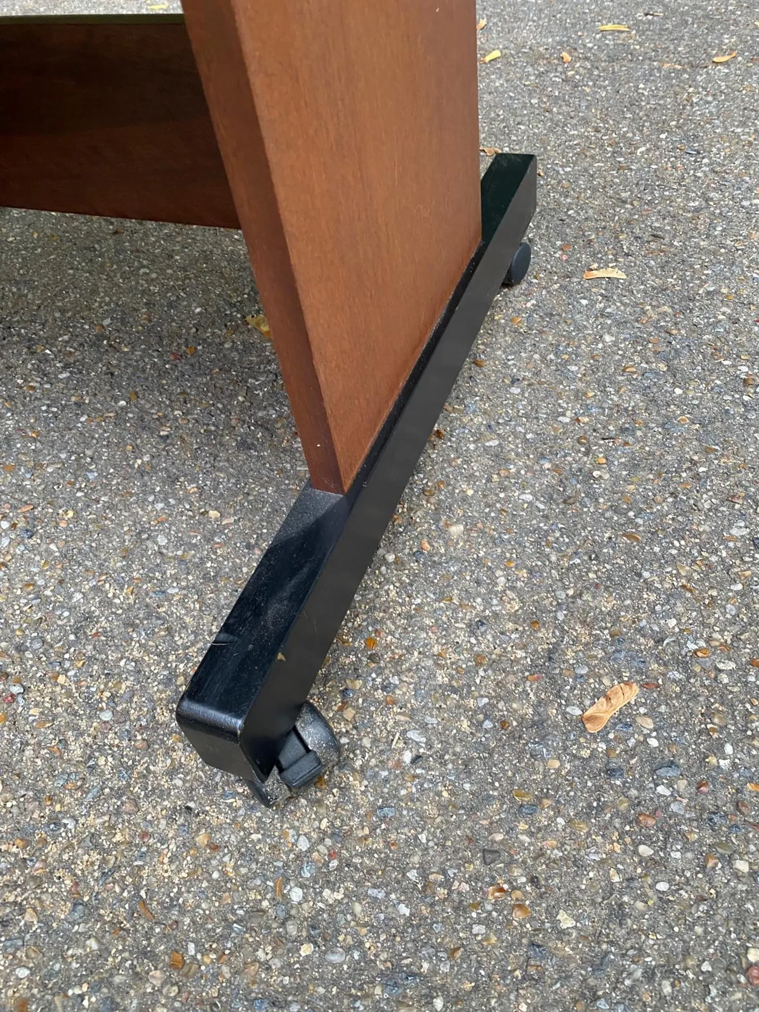 Small Scandinavian-style computer desk on wheels made of wood.