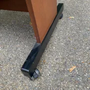 Small Scandinavian-style computer desk on wheels made of wood.