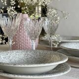 12 speckled ceramic plates.