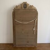 Late 19th century gilded mirror with decorated pediment. 125x70.