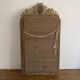 Late 19th century gilded mirror with decorated pediment. 125x70.