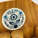 Wall-mounted egg cup holder and wooden utensil holder.