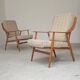 Pair of Boomerang-style armchairs in ecru beige fabric, 1960s.