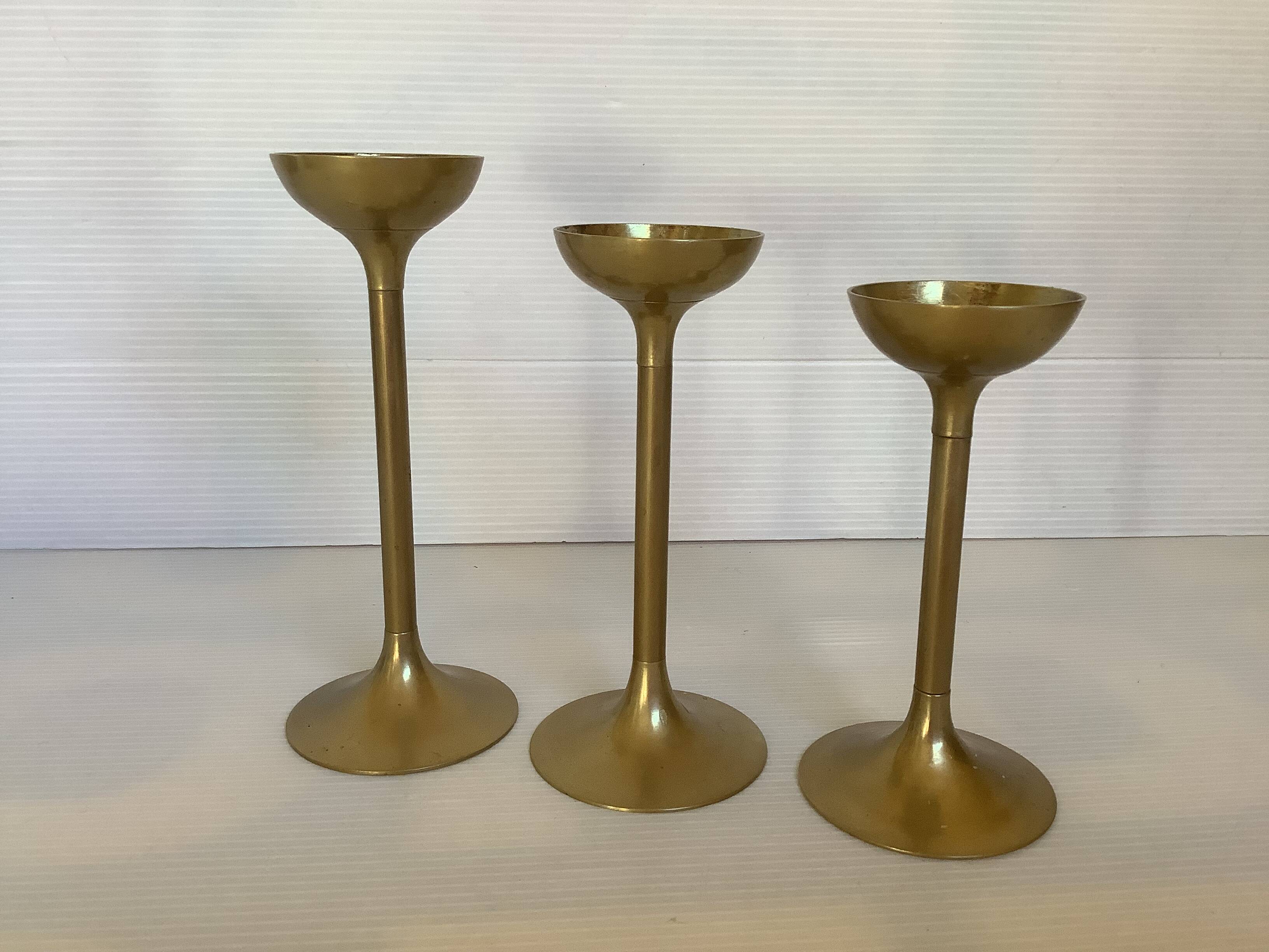 Trio of brass tulip foot candle holders