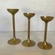 Trio of brass tulip foot candle holders