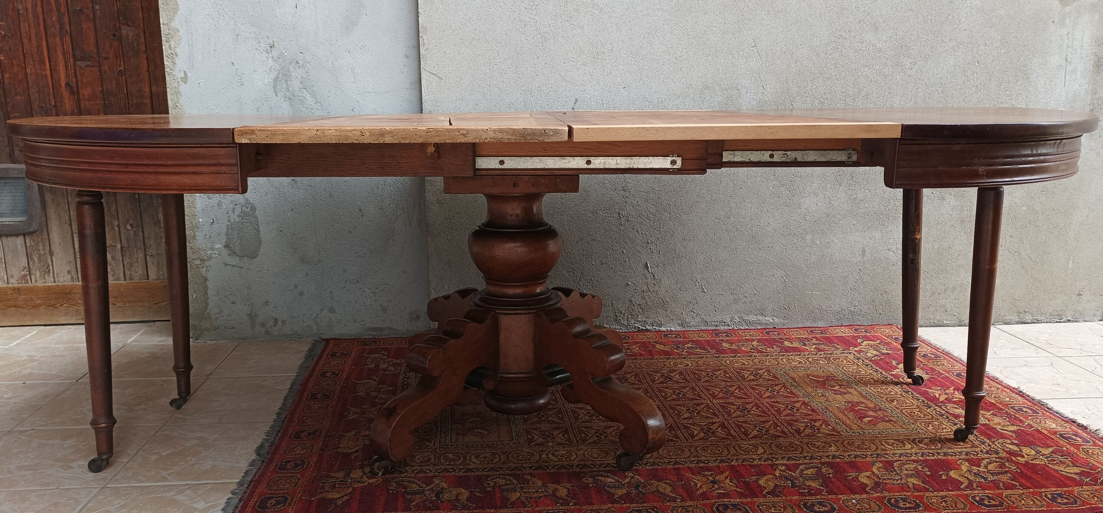 English oval table with 19th century mahogany extensions