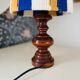 Vintage lamp with turned wooden base, striped wool lampshade