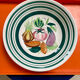 Vintage deep plate with vegetable decoration.