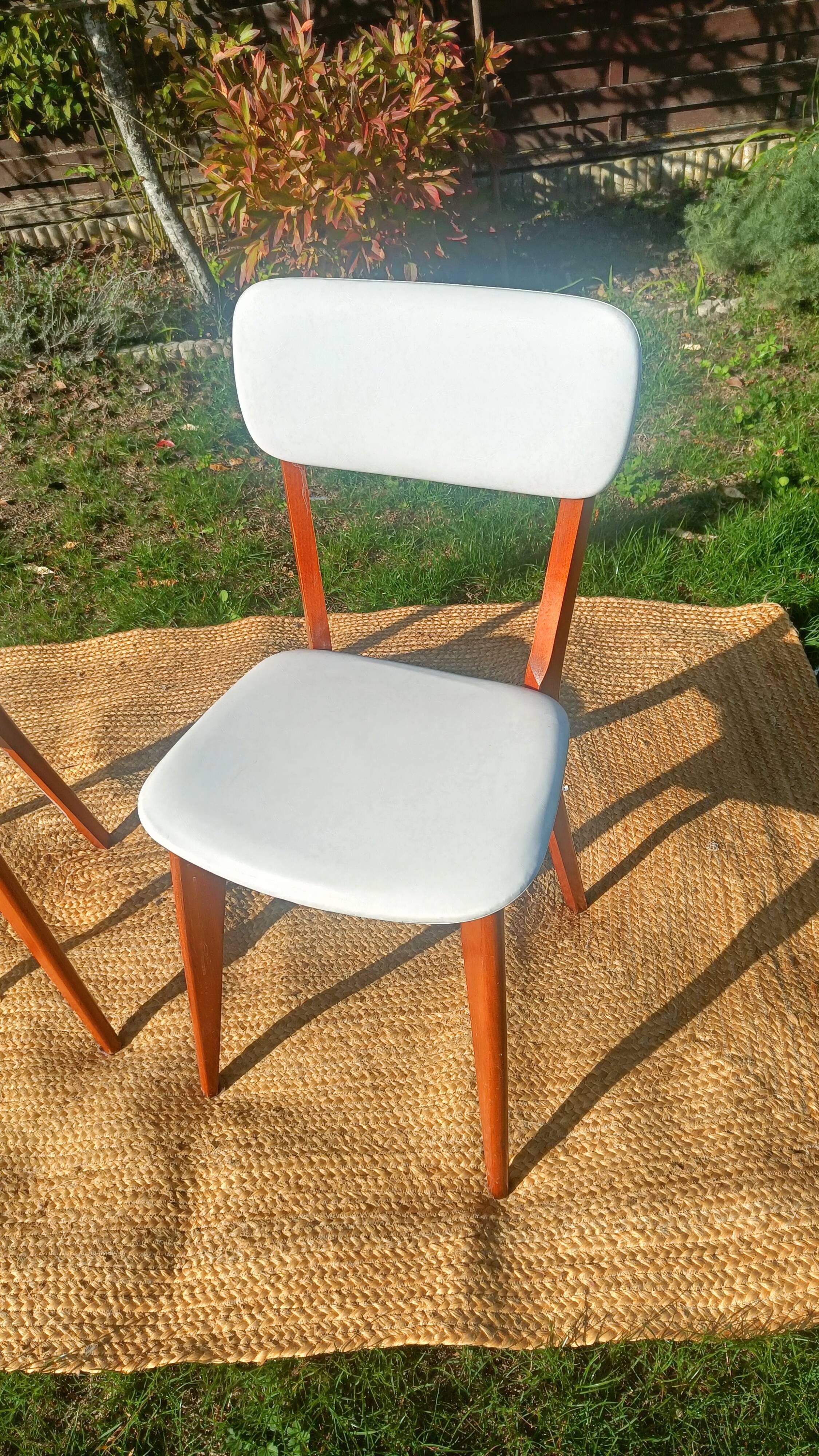 vintage wooden chairs with white faux leather