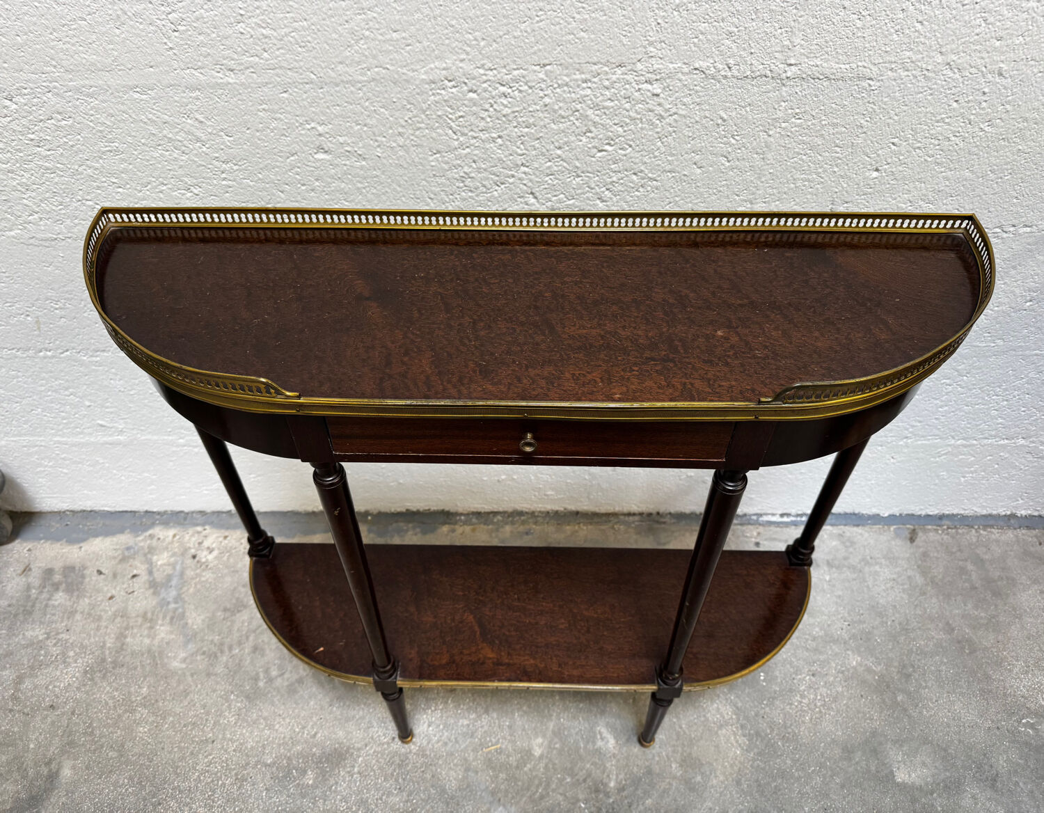 Louis XVI demi-moon console in wood and brass.