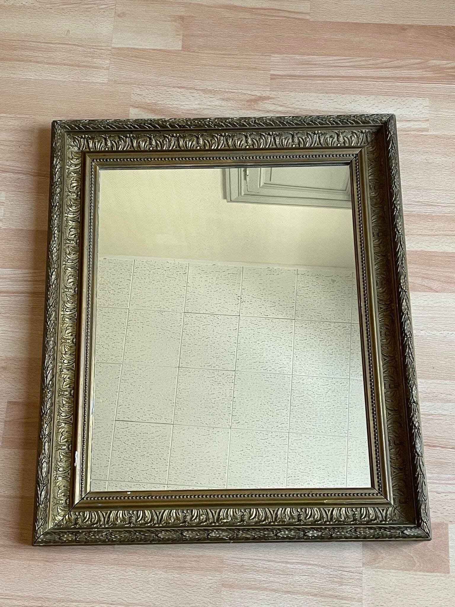 Old mirror with golden wooden frame