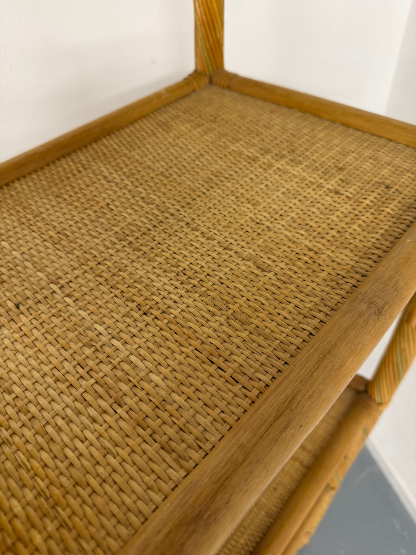 Large woven rattan bookshelf designed in the 1970s.