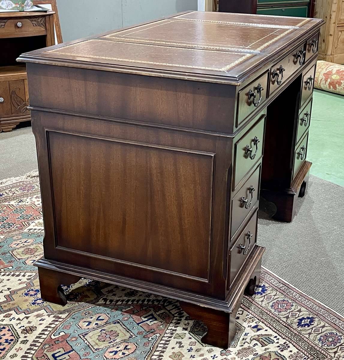 English mahogany pedestal desk with leather top from the 1950s