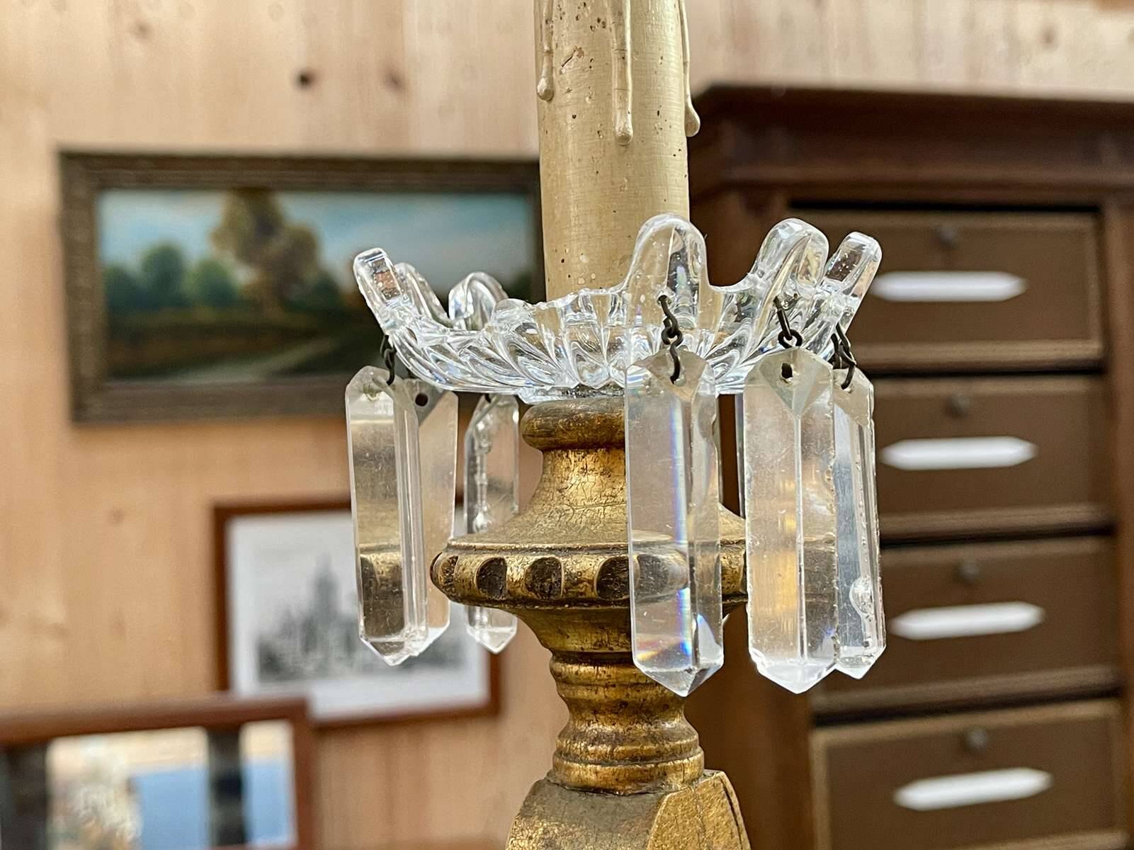 Golden wooden chandelier with crystal pendants from the 19th century.
