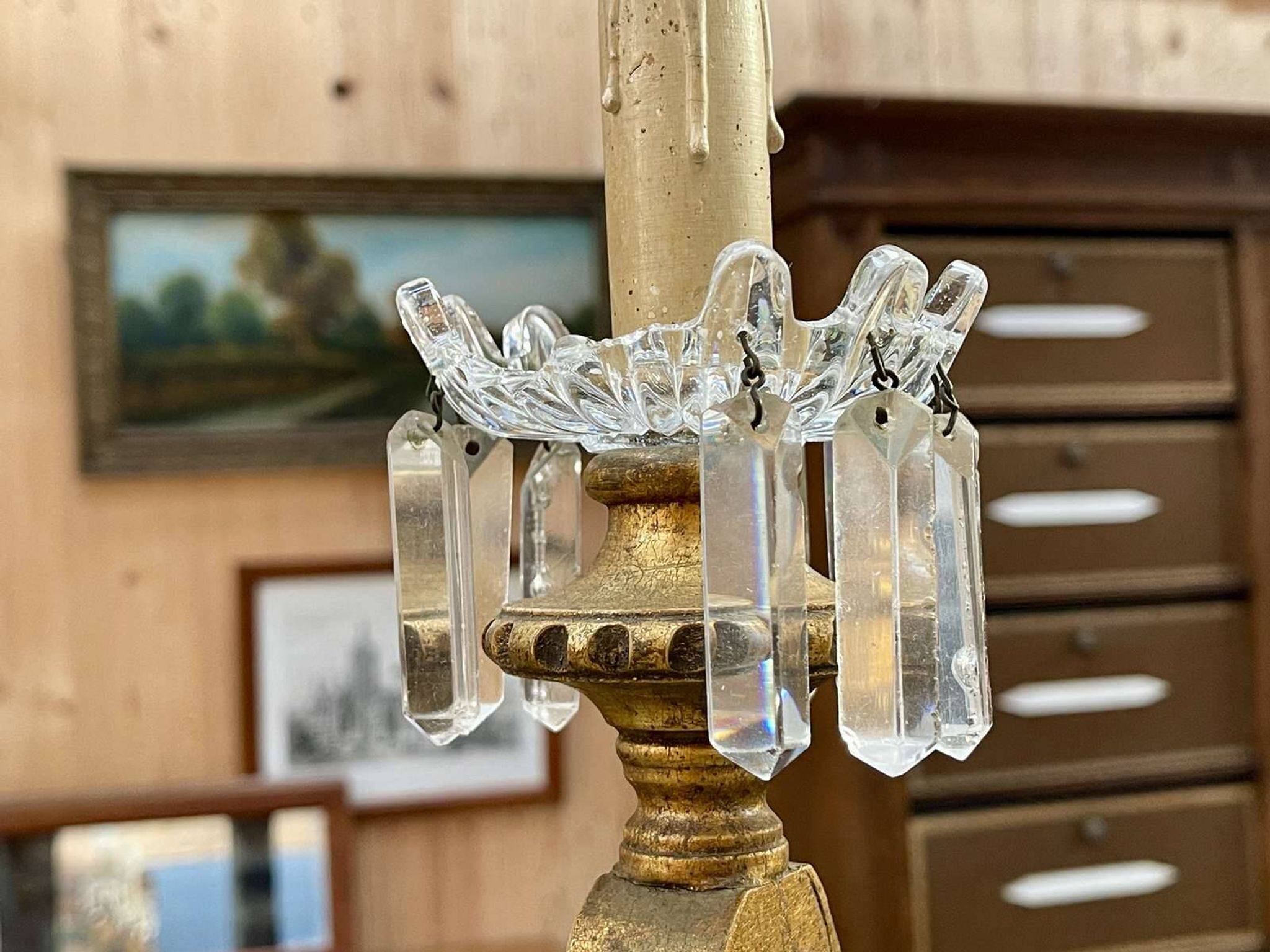 Golden wooden chandelier with crystal pendants from the 19th century.