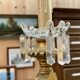 Golden wooden chandelier with crystal pendants from the 19th century.